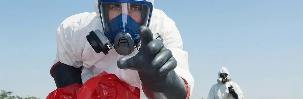 sewage clean up technician wearing protective gear handling biohazard materials in Cincinnati, OH